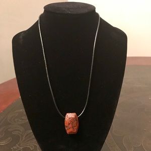 Beautiful red stone on a black cord